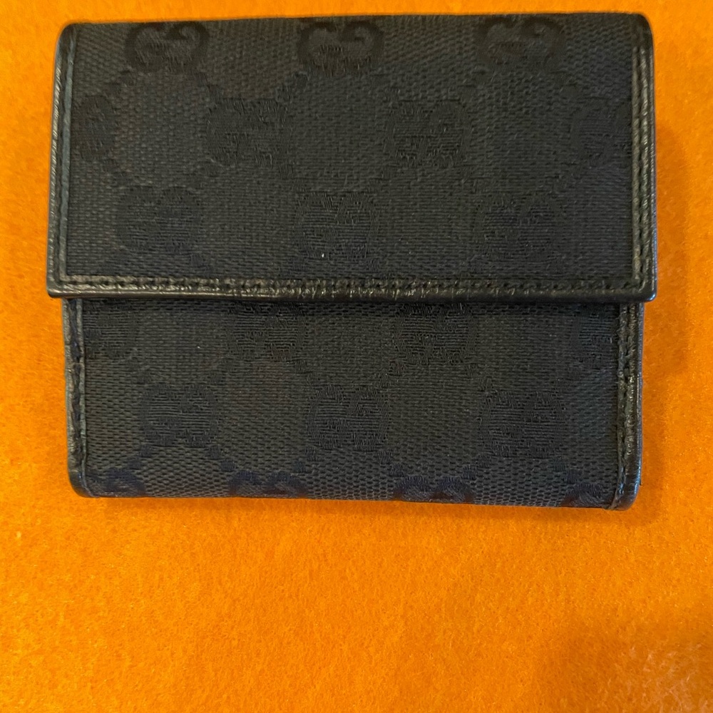 Black signature vintage Gucci wallet with horsebit hardware.